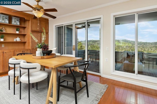 dining room featuring crown molding, ceiling fan, and light hardwood / wood-style flooring