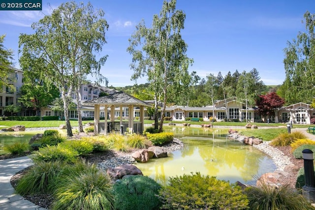 surrounding community with a gazebo and a water view