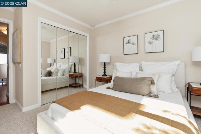 bedroom with ornamental molding, carpet flooring, and a closet