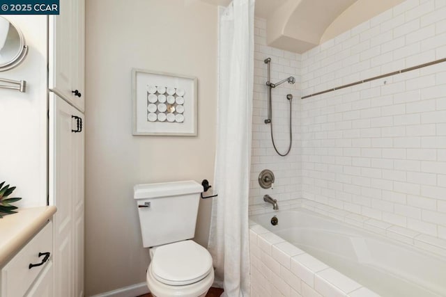 full bathroom with vanity, shower / tub combo, and toilet