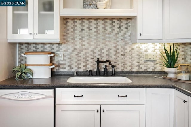 kitchen with sink, decorative backsplash, dishwasher, and white cabinets