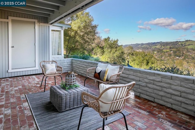 exterior space with a patio, a mountain view, and an outdoor hangout area