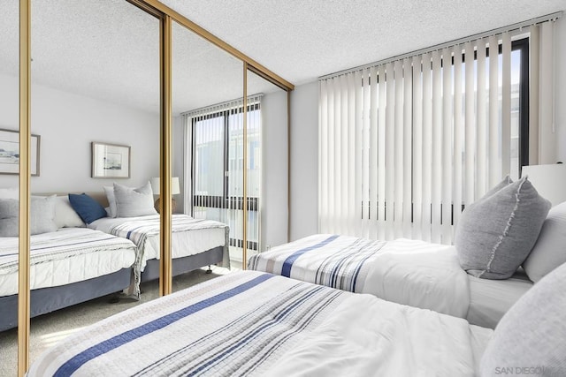 bedroom featuring a textured ceiling and a closet