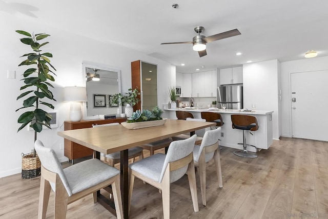 dining area featuring ceiling fan and light hardwood / wood-style floors