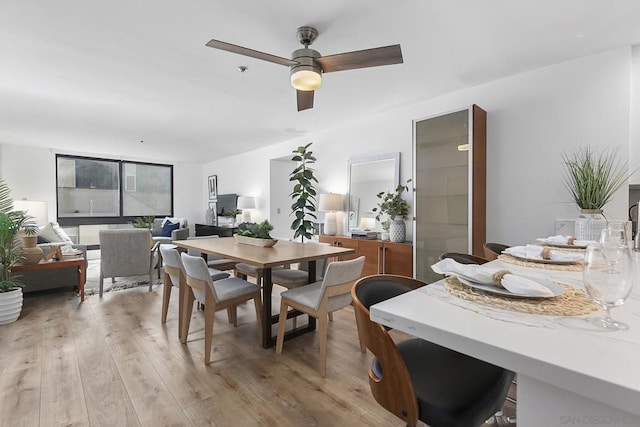 dining room featuring ceiling fan and light wood-type flooring