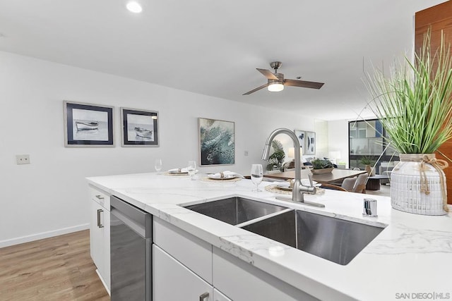 kitchen with dishwasher, sink, white cabinets, ceiling fan, and light wood-type flooring