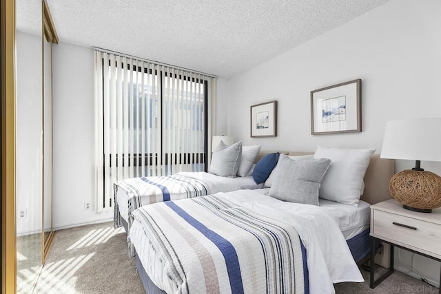 carpeted bedroom featuring a textured ceiling