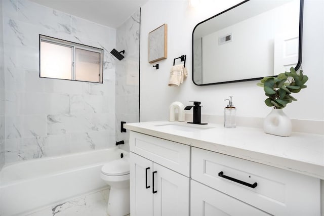 full bathroom featuring tiled shower / bath, vanity, and toilet