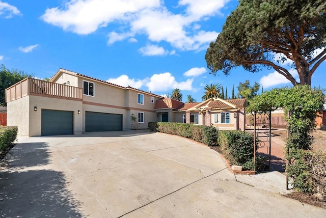 mediterranean / spanish-style home with a garage and a balcony