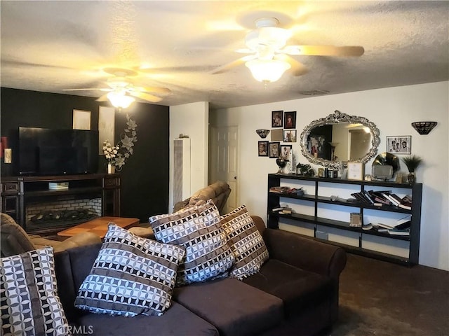 living room with ceiling fan and a textured ceiling