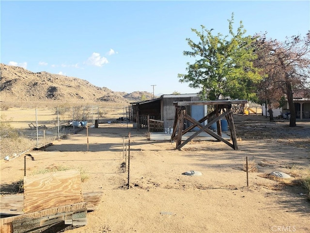 view of yard with a rural view and a mountain view