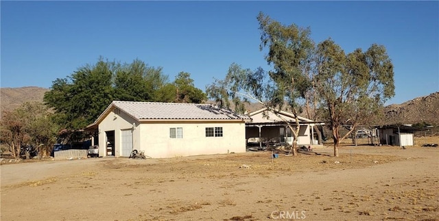 back of property with a mountain view