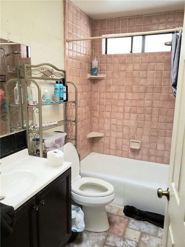full bathroom featuring vanity, toilet, and tiled shower / bath