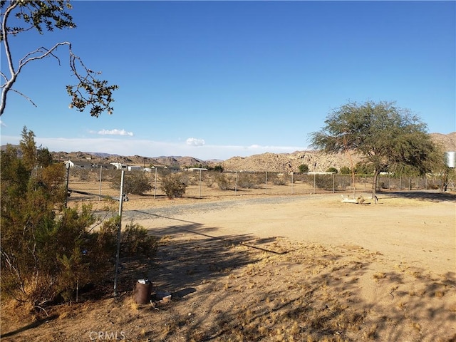 view of yard featuring a mountain view and a rural view