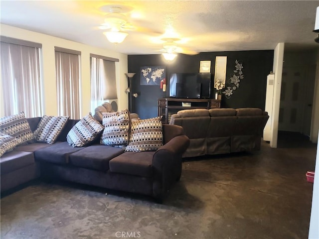 living room with a textured ceiling and ceiling fan