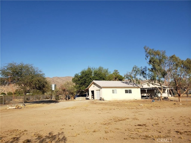back of property featuring a mountain view