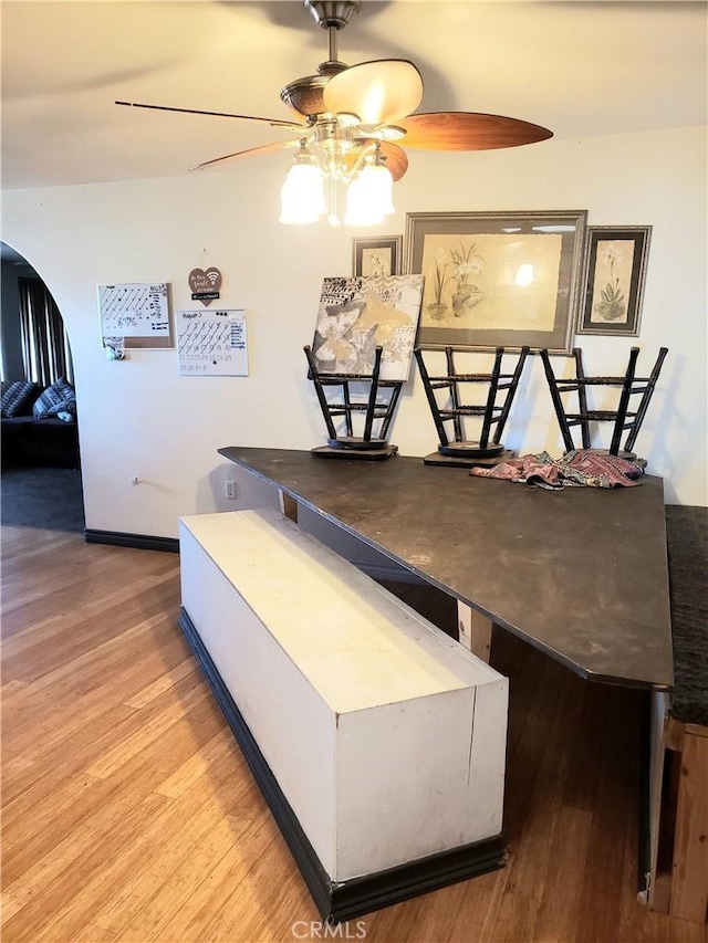 dining area featuring wood-type flooring and ceiling fan