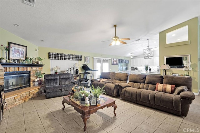 living room featuring a fireplace, vaulted ceiling, a textured ceiling, and light tile patterned floors