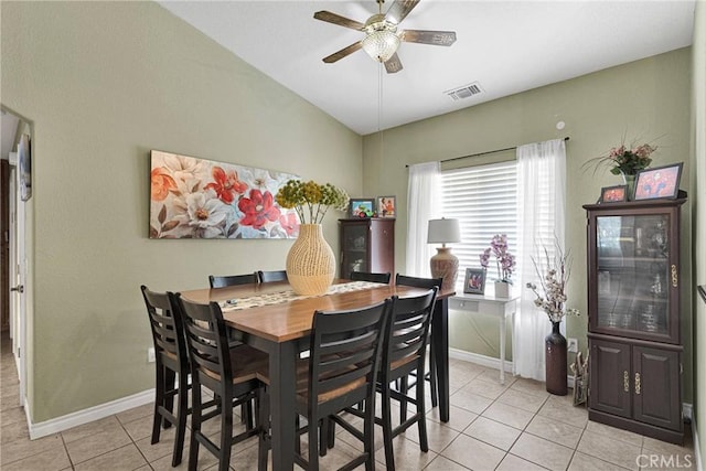 dining area with lofted ceiling, light tile patterned floors, and ceiling fan