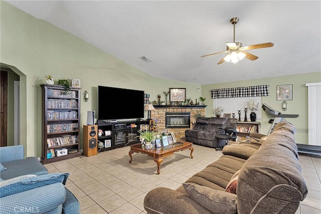 tiled living room with ceiling fan and vaulted ceiling