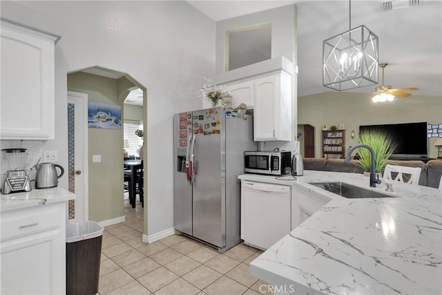 kitchen with sink, decorative light fixtures, white cabinets, and appliances with stainless steel finishes