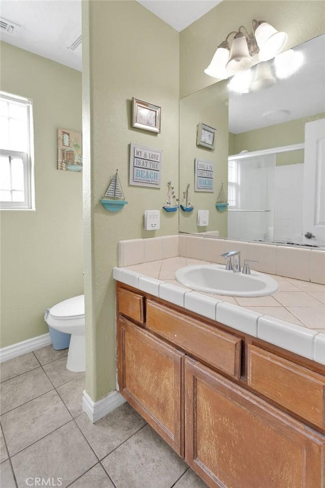 bathroom with vanity, toilet, an enclosed shower, and tile patterned flooring