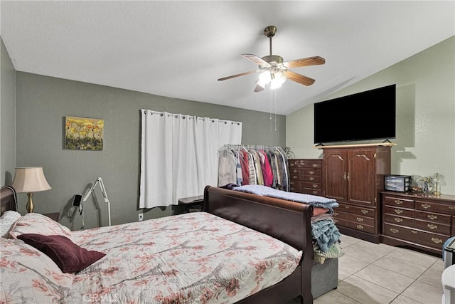 bedroom featuring light tile patterned floors, vaulted ceiling, and ceiling fan