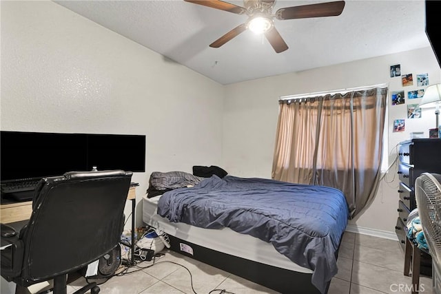 tiled bedroom featuring ceiling fan