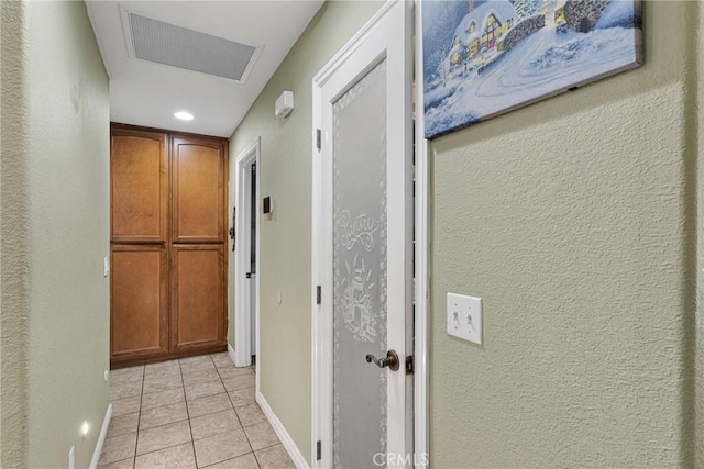 corridor featuring light tile patterned floors