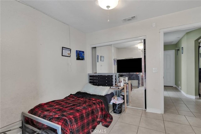 tiled bedroom featuring a closet