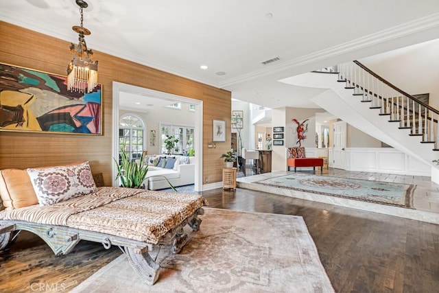 sitting room with crown molding and hardwood / wood-style floors