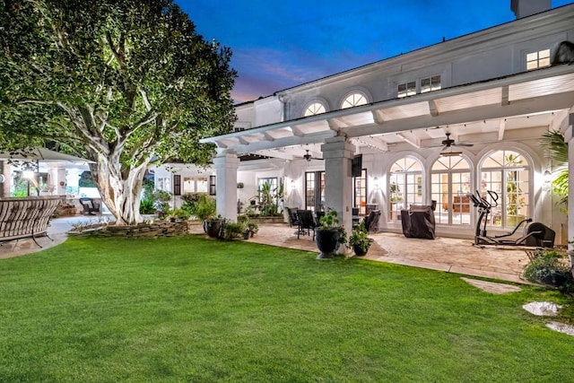 exterior space featuring ceiling fan, a pergola, a patio, and a lawn