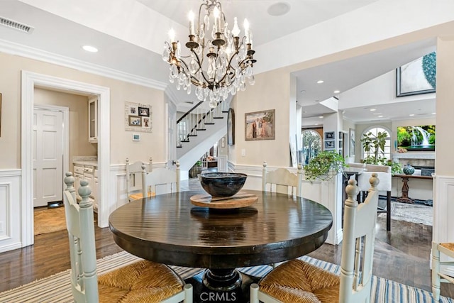 dining room featuring lofted ceiling, hardwood / wood-style floors, and an inviting chandelier