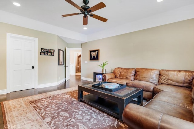 living room with dark hardwood / wood-style floors and ceiling fan