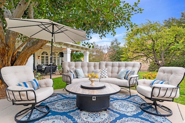 view of patio / terrace with an outdoor living space with a fire pit