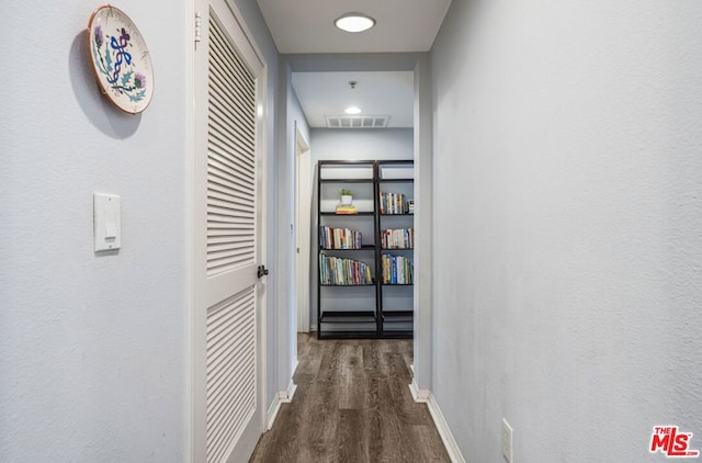 corridor featuring dark hardwood / wood-style floors