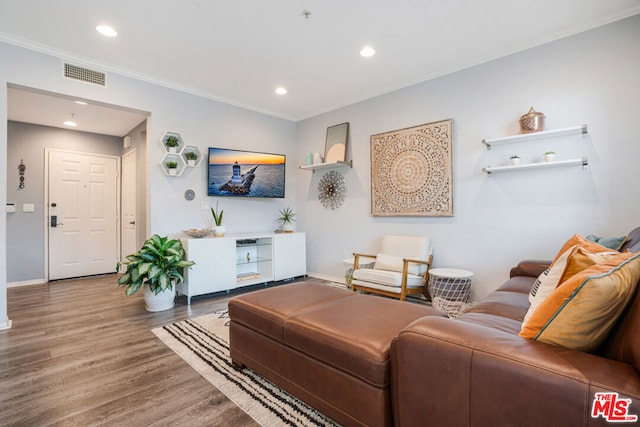 living room featuring crown molding and hardwood / wood-style flooring