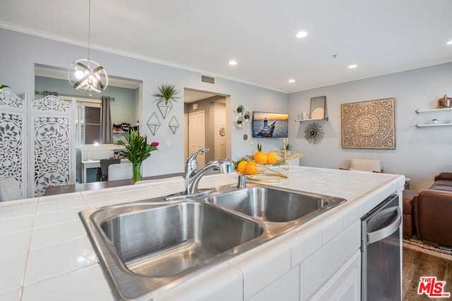 kitchen with white cabinetry, sink, tile counters, and decorative light fixtures