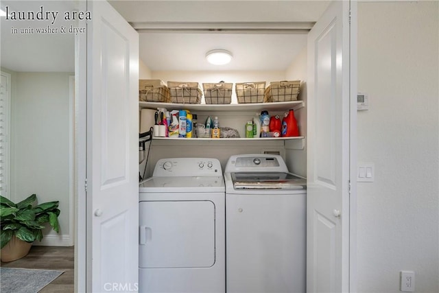 laundry area featuring separate washer and dryer and hardwood / wood-style flooring