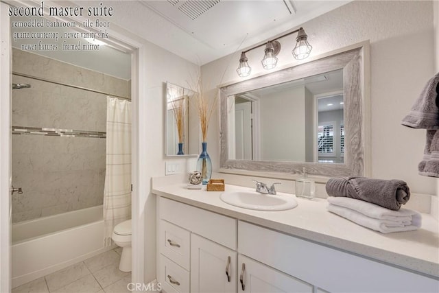 full bathroom with vanity, shower / tub combo with curtain, tile patterned floors, and toilet