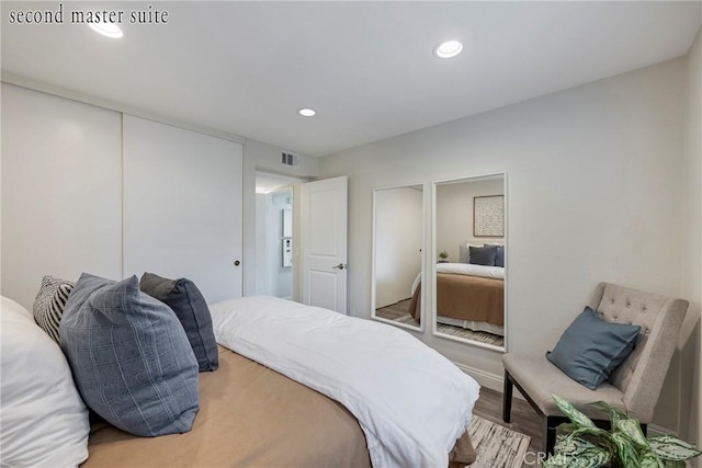 bedroom with hardwood / wood-style flooring