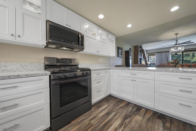 kitchen with white cabinetry, dark hardwood / wood-style floors, range with gas stovetop, kitchen peninsula, and ceiling fan