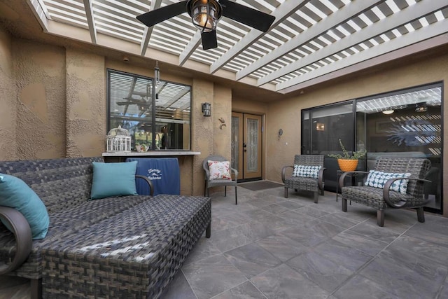 view of patio with an outdoor living space and ceiling fan