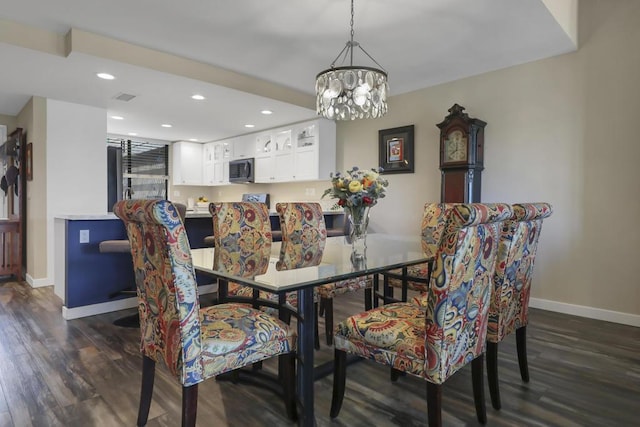 dining room featuring an inviting chandelier and dark hardwood / wood-style flooring