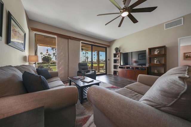 living room featuring dark wood-type flooring, french doors, and ceiling fan