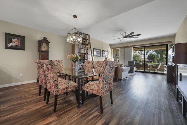 dining space with dark wood-type flooring and ceiling fan with notable chandelier