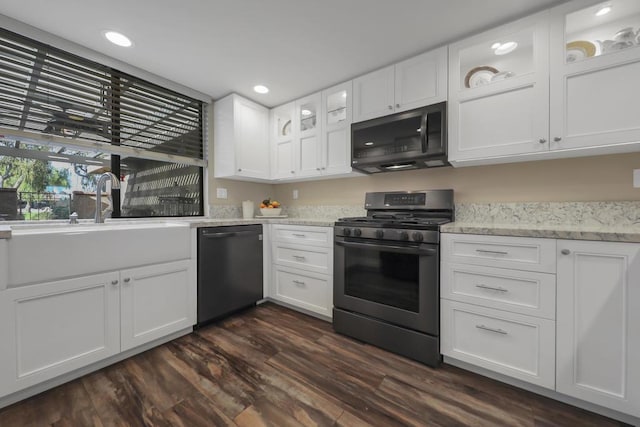 kitchen with black dishwasher, gas stove, and white cabinets