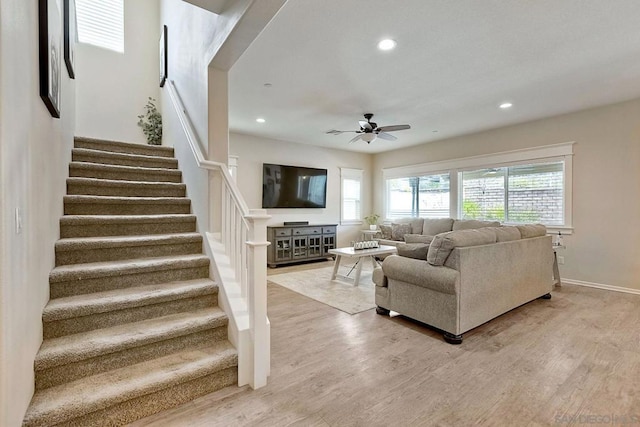 living room with ceiling fan and light wood-type flooring