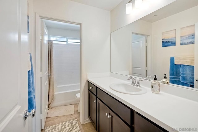 full bathroom featuring toilet, vanity, and shower / bath combo with shower curtain