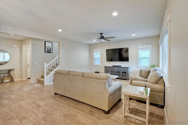 living room with ceiling fan and light hardwood / wood-style floors